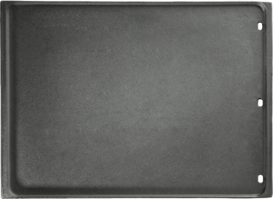 Plaque de cuisson réversible en fonte émaillée Napoléon posée sur barbecue, avec surface nervurée et trous de drainage visibles